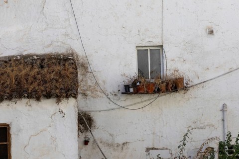 On the road to the white villages. Beautiful windows of the historic old town in Setenil de las