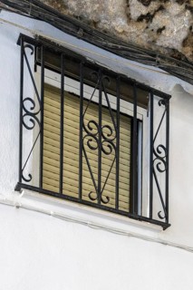 On the road to the white villages. Beautiful windows of the historic old town in Setenil de las