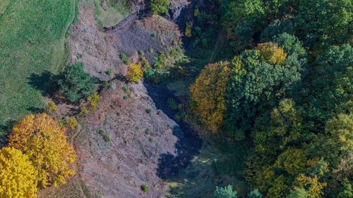 Colourful autumn leaves surround an extinct volcano. The landscape shows bright colors and a