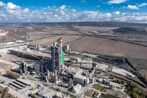 Aerial view of a sprawling industrial complex with rural fields in the background. Aerial view to