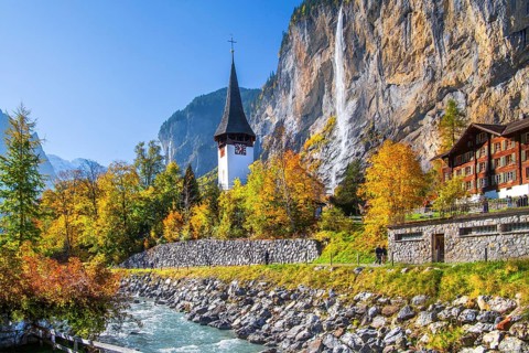 Village church with Staubbach waterfall in autumn, Lauterbrunnen, Bernese Oberland, Canton of Bern,