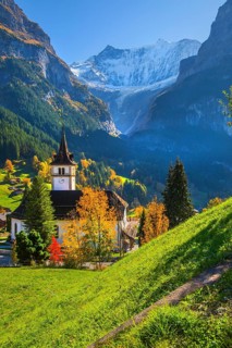 Village church in the town center with fieschörner 4049m in autumn, Grindelwald, Lütschinental,