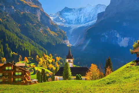 Village church in the town center with fieschörner 4049m in autumn, Grindelwald, Lütschinental,