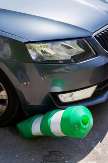 Car bending white and green safety traffic post with front bumper, wrong parking, car insurance,