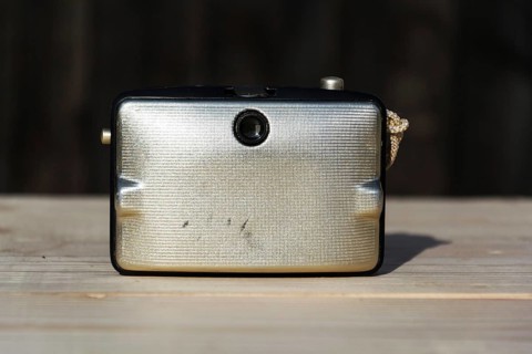 Back of old vintage golden Penti I camera, wooden background Prague Czech republic