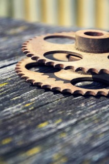 Filtered picture of cogwheels on a colorful wooden background Prague, Czech republic