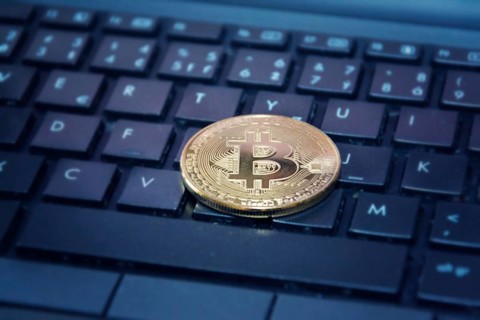 Golden bitcoin coin on computer keyboard, cryptocurrency bitcoin mining concept Prague Czech