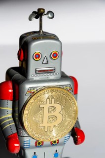 Vintage tin toy robot with bitcoin coin, cryptocurrency mining concept Prague Czech republic