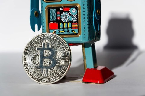 Vintage tin toy robot with bitcoin coin, cryptocurrency mining concept Prague Czech republic