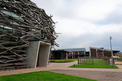 Capi hnizdo Storks Nest riding arena covered with wood resembling a giant birds nest on November