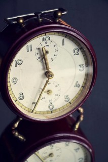 Filtered picture of a vintage alarm clock on a mirror backgroud Prague Czech republic