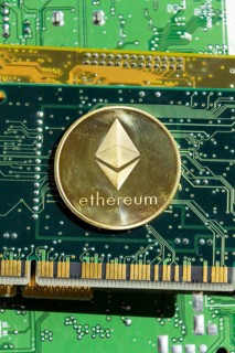 Golden ethereum coin lying on computer motherboard, cryptocurrency investing concept Prague, Czech