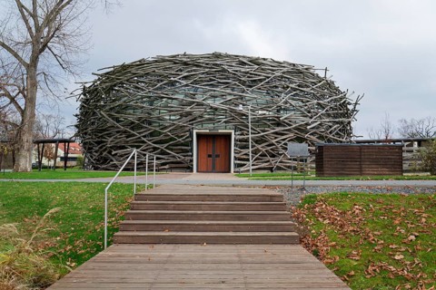 Capi hnizdo Storks Nest riding arena covered with wood resembling a giant birds nest on November