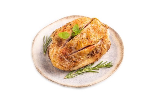 Fried Turkey Thigh with spices and rosemary on plate isolated on white background. side view, close