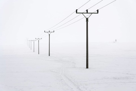 Electricity pylons from distribution power station in foggy winter freeze Prague Czech republic