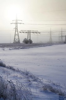 Electricity pylons from distribution power station in foggy winter freeze Prague Czech republic