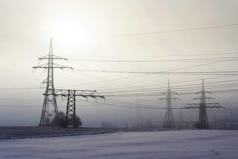 Electricity pylons from distribution power station in foggy winter freeze Prague Czech republic