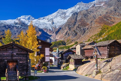Typical granaries on the outskirts of the village with Alphubel 4206m and Mischabel group 4545m in