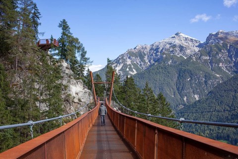 Mount Serles with suspension bridge on the Sunnenseit'n-Weg hiking trail, in autumn, Neustift im