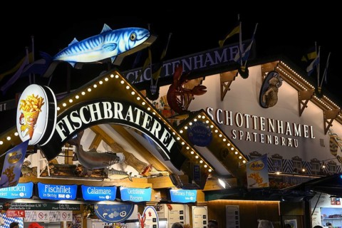 Fish bar and spade party tent at Oktoberfest, Schottenhamel, night view, Munich, Bavaria, Germany