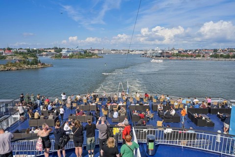 Passengers at the stern, Viking Line XPRS ferry leaves port, Helsinki, Finland