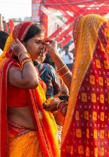 Hindu devotees gather on the banks of the Brahmaputra River to offer prayers to the Sun God on the