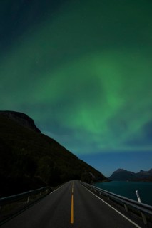 Tysfjord near Stetind Mountain in northern Norway under auroras and full moon