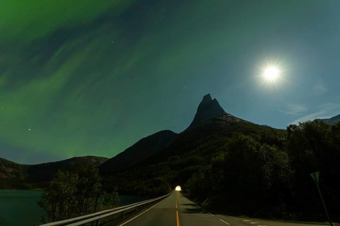 Magical Stetind mountain in northern Norway under auroras and full moon