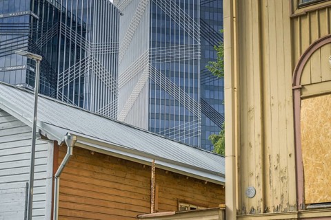 Modern office buildings, high-rise buildings, small old building, wooden house, Maakri-Kvartal