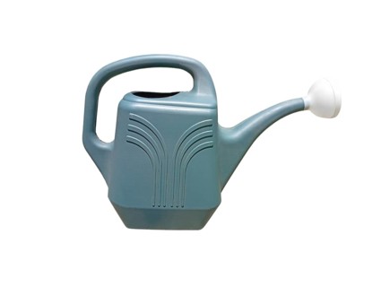 Close-up of a plastic garden watering can on a white background