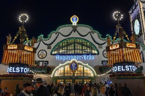 Wies'n visitors in front of the Augustiner festival tent, night view, Oktoberfest, Munich, Bavaria,
