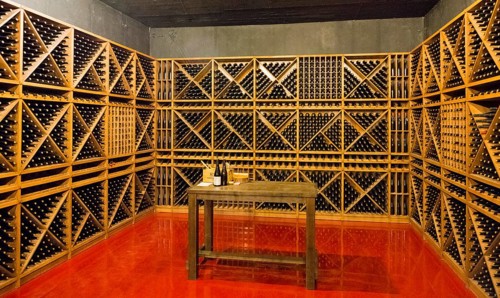 Empty minimalistic wine cellar with wine bottle racks and a table, Hin Areni Winery, Areni Village,