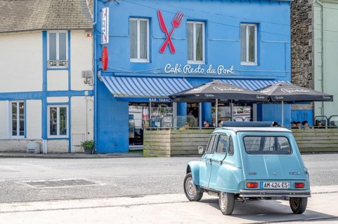 Parked sky blue Citroen 2CV with roll top in front of Café Resto du Port Le Surcouf, a popular