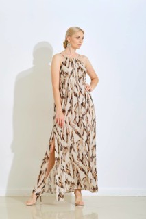 A woman stands confidently wearing a fashionable long dress featuring a unique pattern. She poses