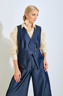 A model showcases a stylish blue vest paired with wide-leg pants and a light shirt. The outfit