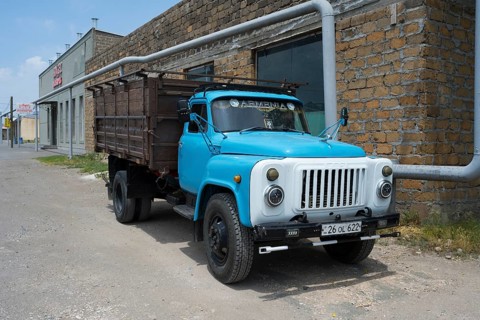 Old blue truck in front of a brick wall in an urban environment, GAZ-53 truck, Ararat, Ararat
