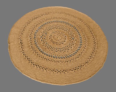 Round crocheted rug on a gray background
