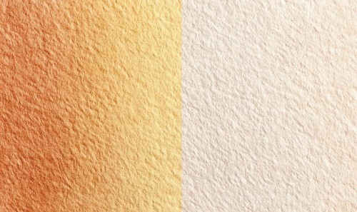 Two tan and white surfaces with a slight orange hue. The surfaces are slightly textured and appear