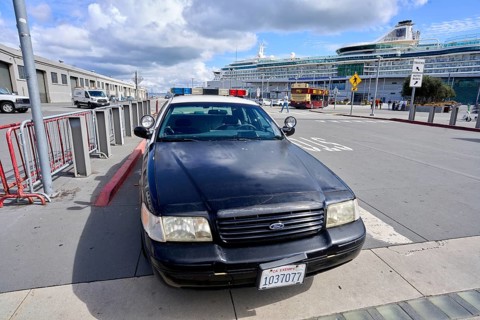 Police vehicle in front of a cruise ship near Fisherman's Wharf in San Francisco
