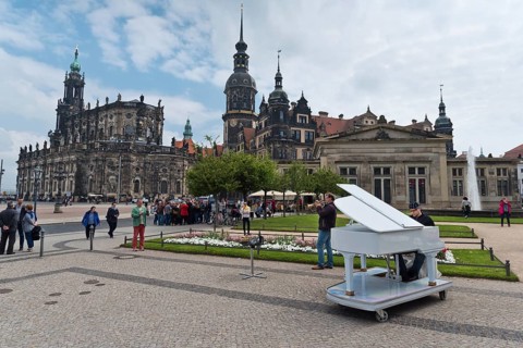 Dresden, Gerrmany- May 6, 2017: Musicians are playing on the sqare in the background Cathedral of