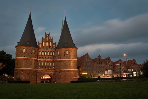 LUBECK, GERMANY - AUGUST 3, 2016: Holstentor Gate during twilight. Lubeck old town is on a UNESCO