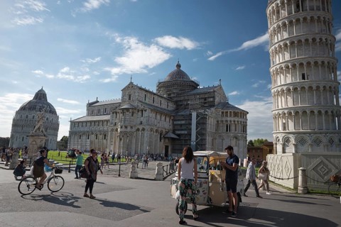 PISA, ITALY - JUNE 15, 2016: Pedestrians near the Pisa Leaning tower, in Square of Miracles (Piazza