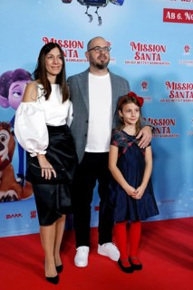 Director Damjan Mitrevski with woman and daughter at a special screening of MISSION SANTA - AN ELF