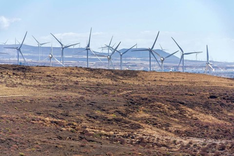 Onshore wind turbines at wind farm on sunny summer day, sustainable renewable electricity concept,