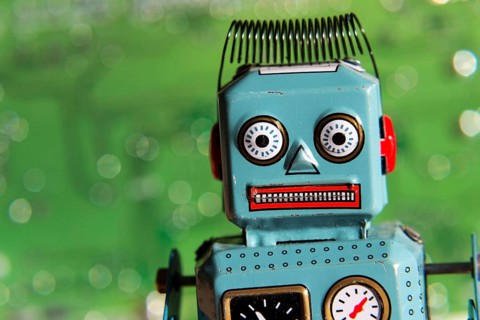 Vintage tin toy robot with computer board, artificial intelligence concept