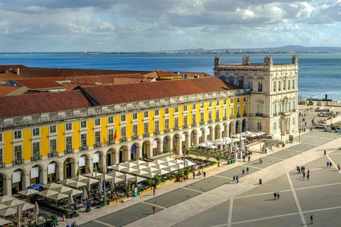 Scenic view of Commerce Square or Praca do Comercio in Lisbon, Portugal, iconic yellow Pombaline
