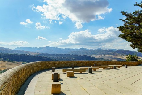Ronda, malaga, spain viewpoint terrace offers stone benches for relaxing while observing the scenic