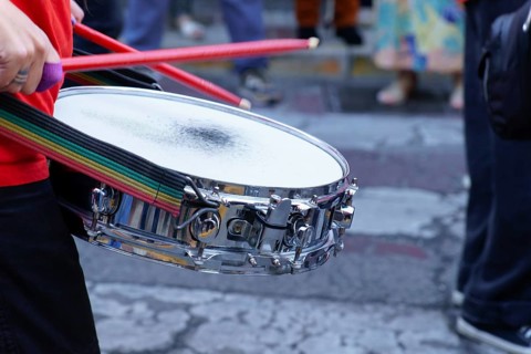 Ronda, malaga, spain Drummer playing snare drum with red drumsticks during a vibrant street parade,