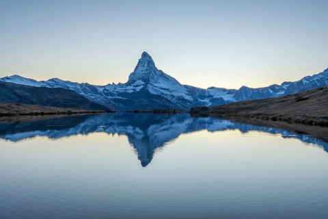 Matterhorn Mountain and Reflection in Lake Stellisee in Evening Twilight. Swiss Alps. Valais,