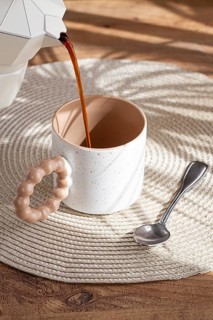 Pouring fresh coffee into a ceramic cup, geyser coffee maker, natural light, breakfast